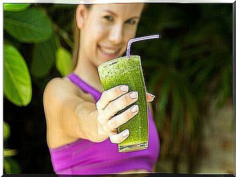 Woman with a cucumber smoothie in hand