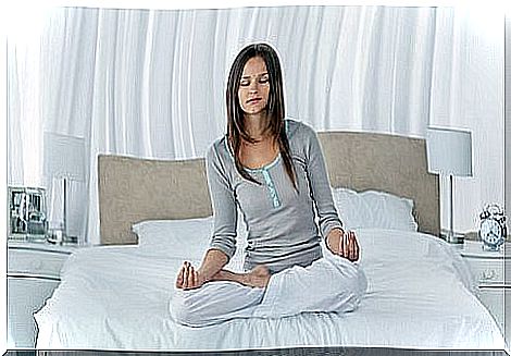 woman in bed doing stress exercises