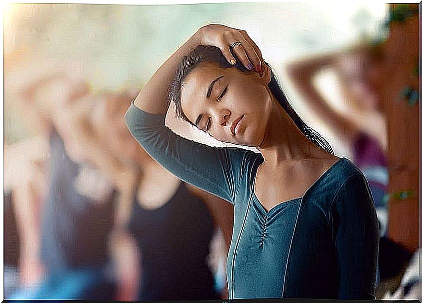 Girl doing a neck stretch in yoga class.