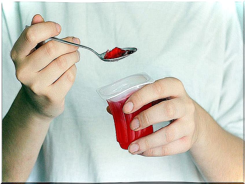 Woman catching a spoonful of jelly.